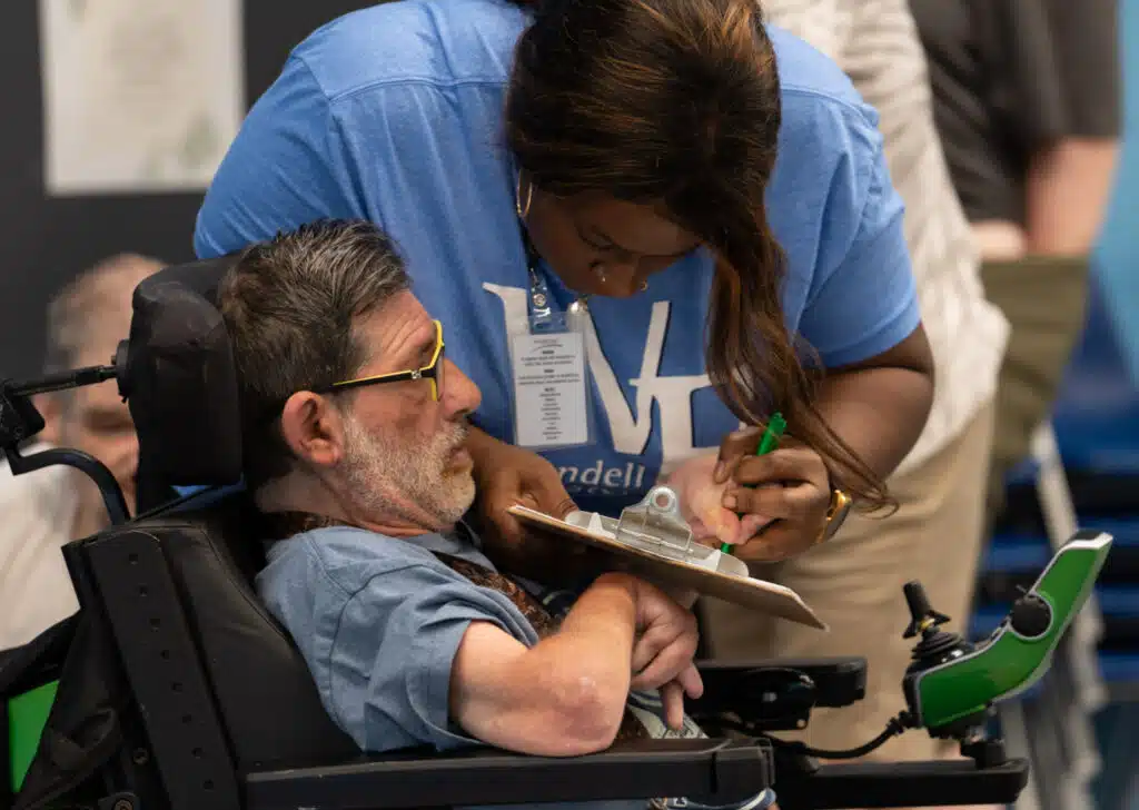 A staff member assisting a Day Training participant.