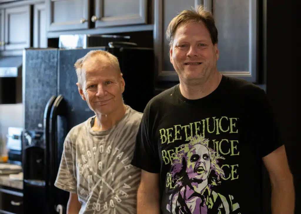 Two men smiling