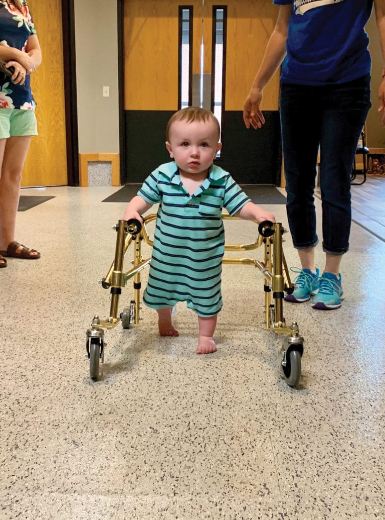 A toddler walking during Physical Therapy