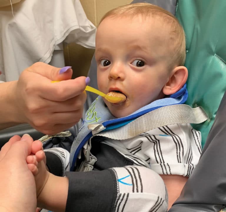 A young boy learning swallowing skills during Speech Therapy