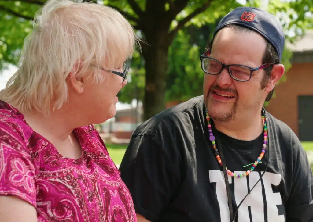 Man and woman talking to each other and smiling